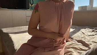 A Girl In A Pretty Pink Dress Indulges In Some Playful Exploration